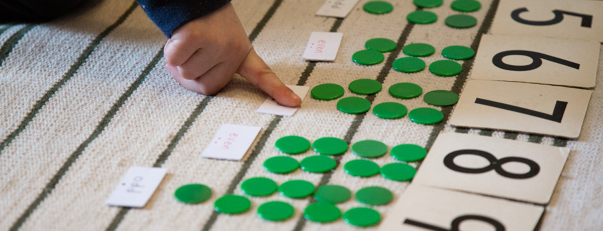 Counting: child pointing at green circles for numbers (Grantham Farm Montessori School)
