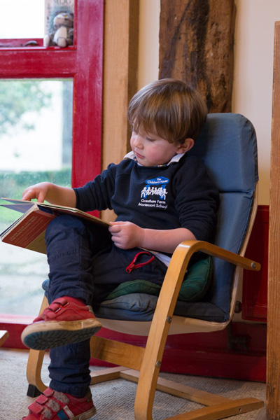 Boy reading (Grantham Farm Montessori School)