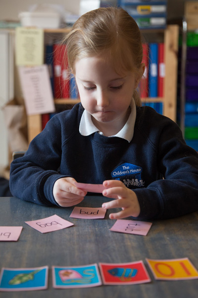 Girl with words on cards (Grantham Farm Montessori School)