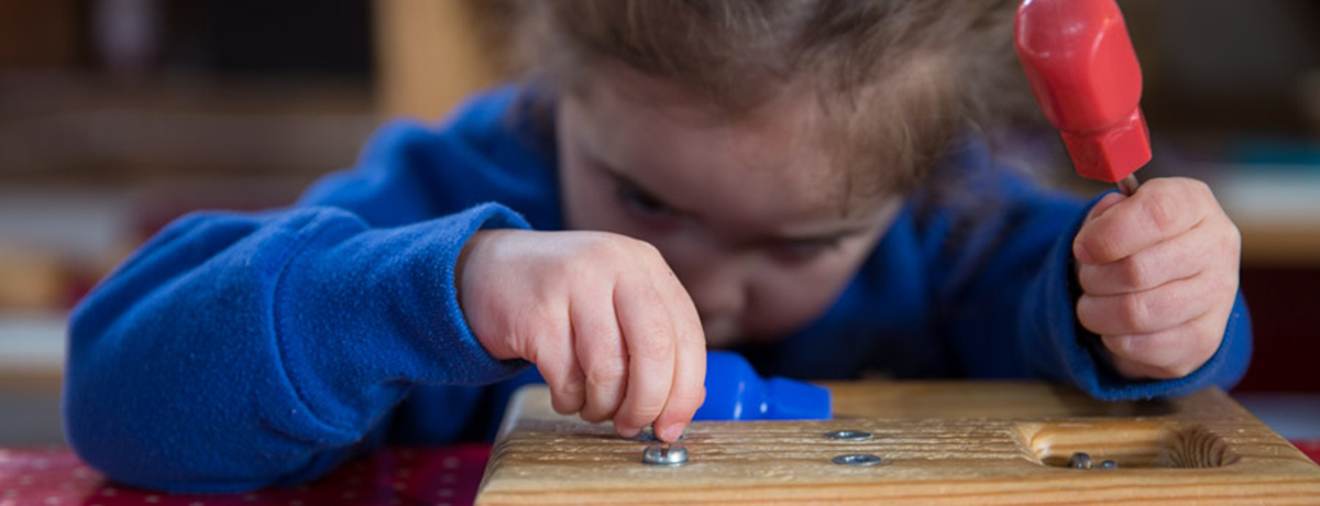 Child with screwdriver (Grantham Farm Montessori School)